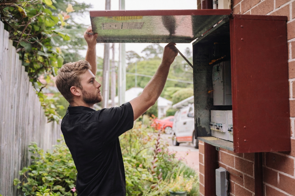 Electrician installing downlights in a Earlwood home